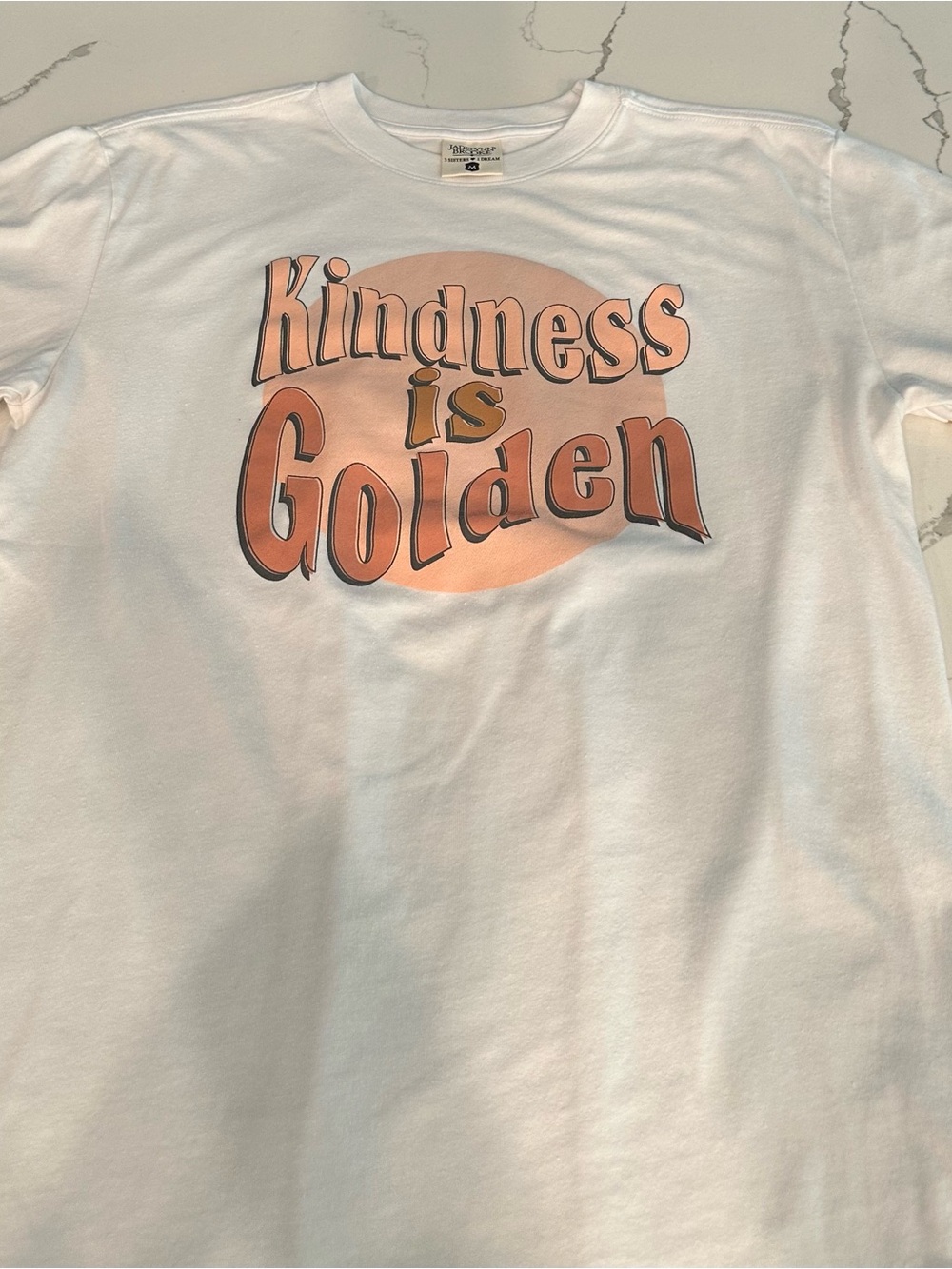 Jadelynn Brooke White Tee with Peach/Gold 'Kindness is Golden' Graphic